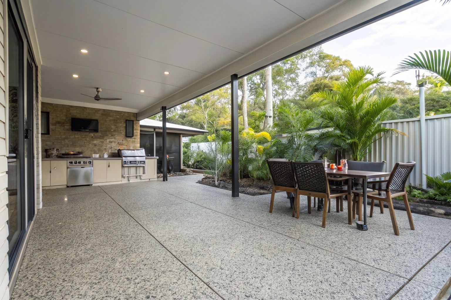Exposed aggregate concrete patio for outdoor entertaining area in Townsville home