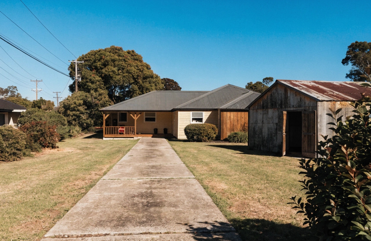Rasmussen family home with concrete driveway and shed access